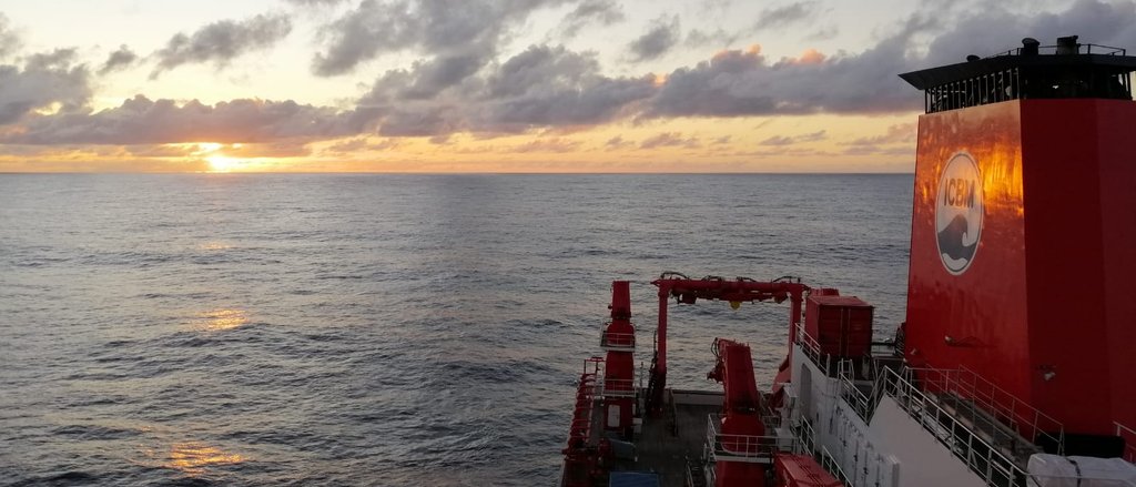 Research vessel of ICBM on sea. Sunset and clouds in the background.